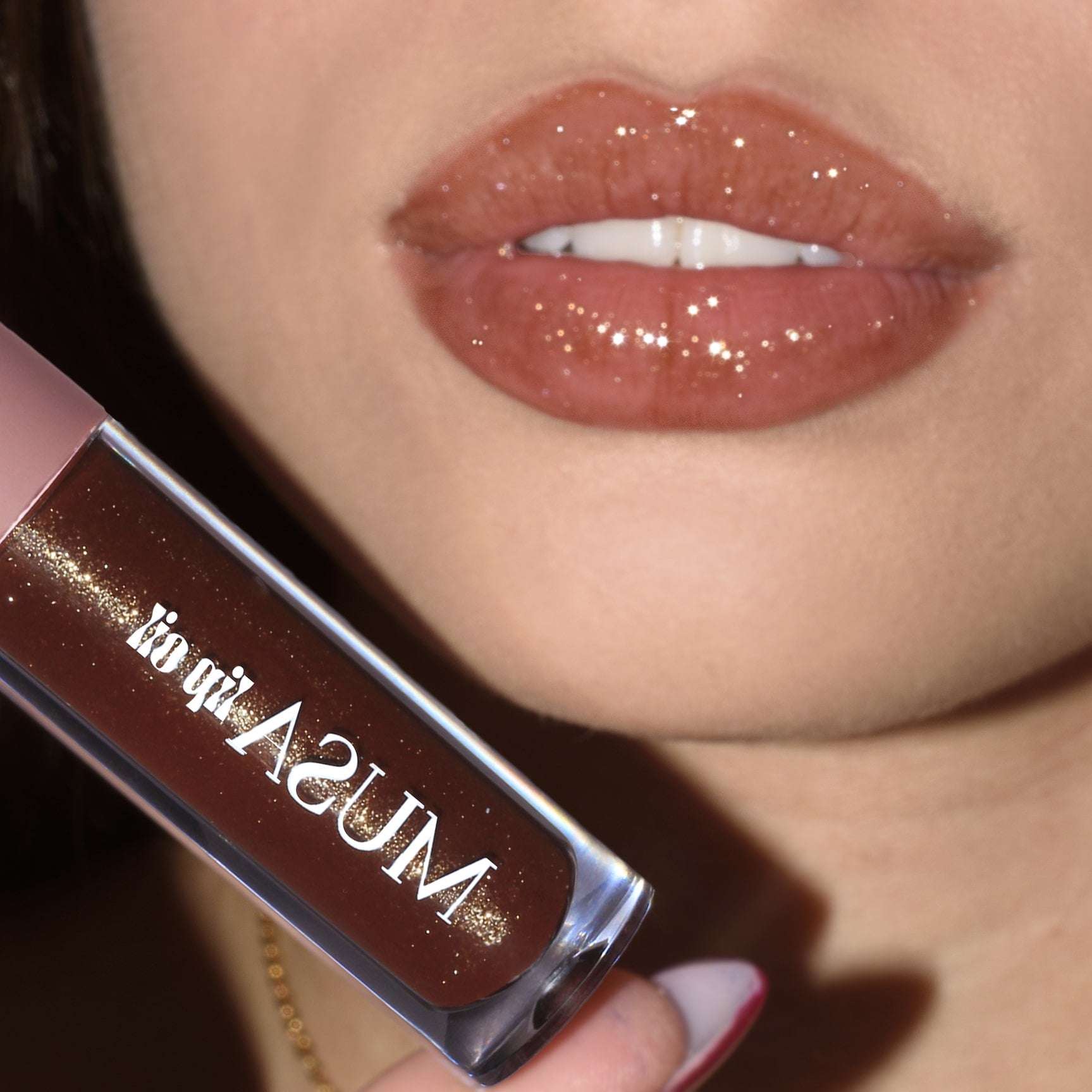 Lips with brown lip oil and gold glitter.