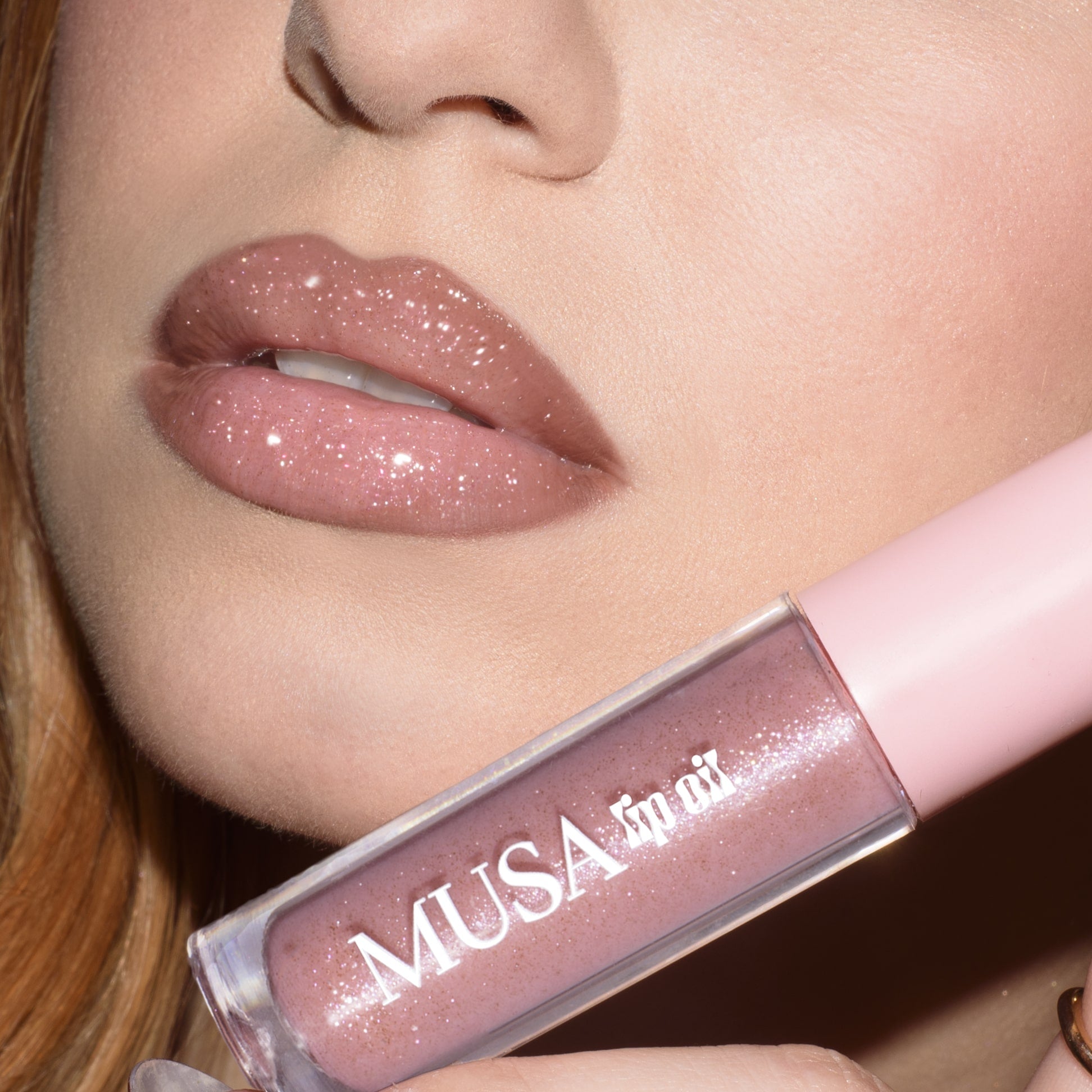 Lips with pink lip oil and silver glitter.