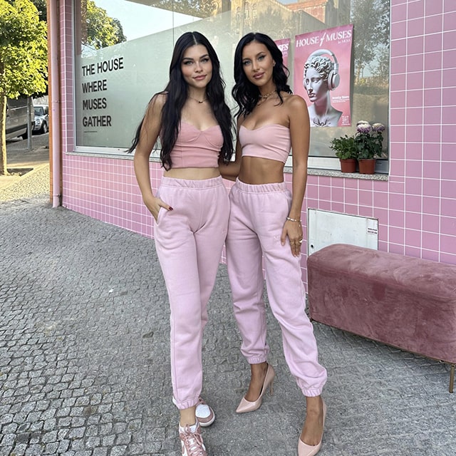 Besties wearing the same aesthetic pink tracksuit.